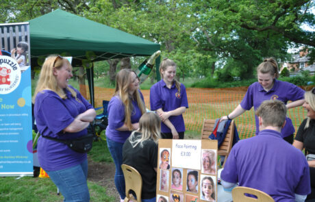 Staff taking part in face painting fun